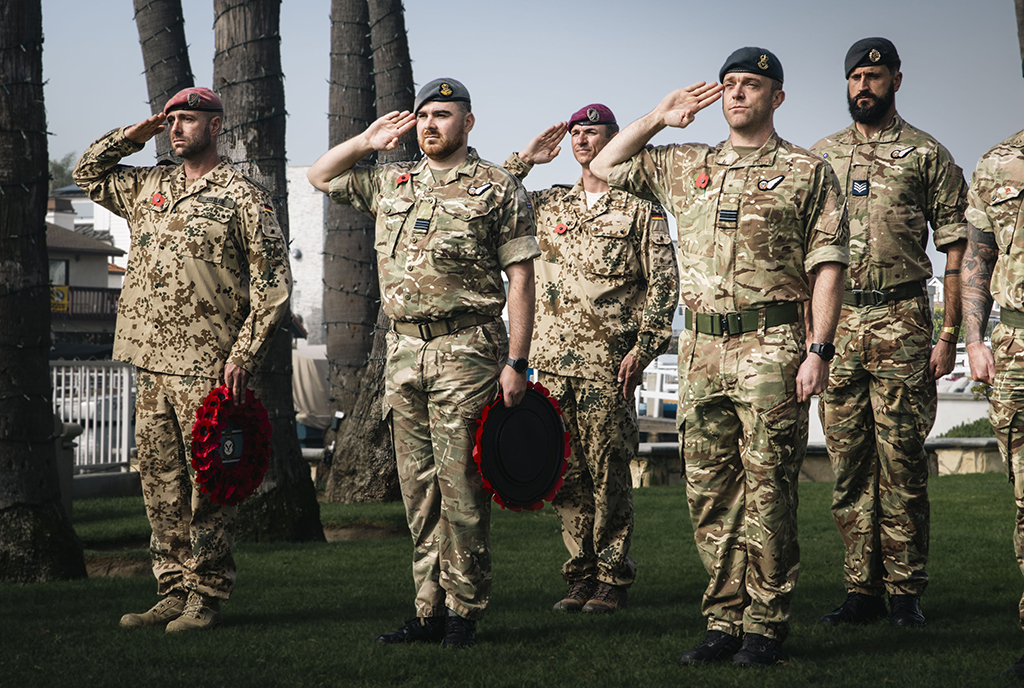 Members of the Royal Air Force Falcons Parachute Display Team, standing together with Parachute School members from the German Army, during an Act of Remembrance Ceremony.